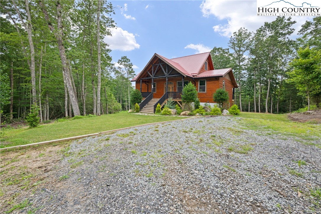 449 Hampton Ridge Road Fleetwood, NC 28626 - Photo 42 of 43 a front view of a house with a yard