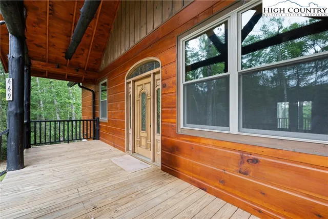 a view of a two room with wooden floor and walls