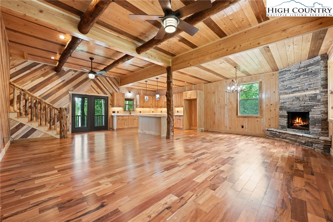 449 Hampton Ridge Road Fleetwood, NC 28626 - Photo 6 of 43 a view of a room with wooden floors and fireplace