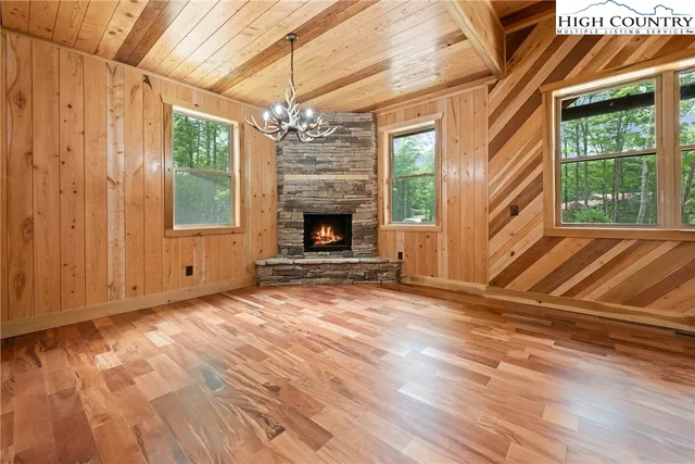 a view of empty room with fireplace and windows