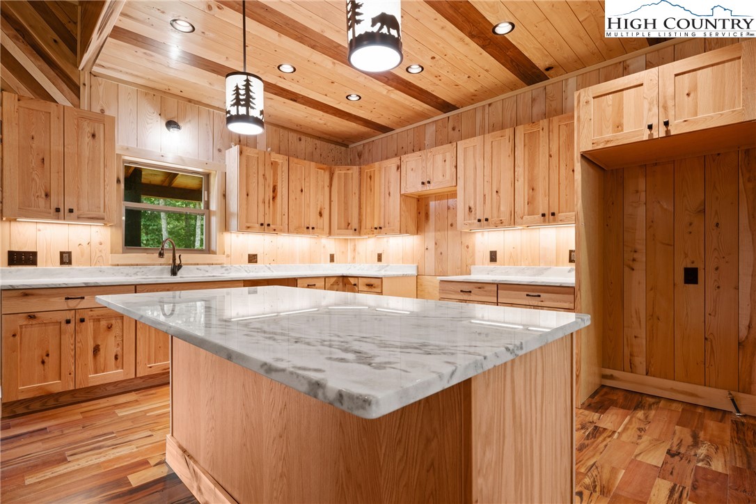 449 Hampton Ridge Road Fleetwood, NC 28626 - Photo 10 of 43 a kitchen with stainless steel appliances granite countertop a sink stove and refrigerator