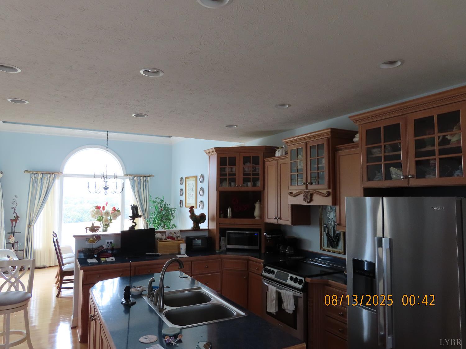 6485 Falling Creek Road Bedford, VA 24523 - Photo 14 of 50 a kitchen with stainless steel appliances a dining table chairs and a refrigerator
