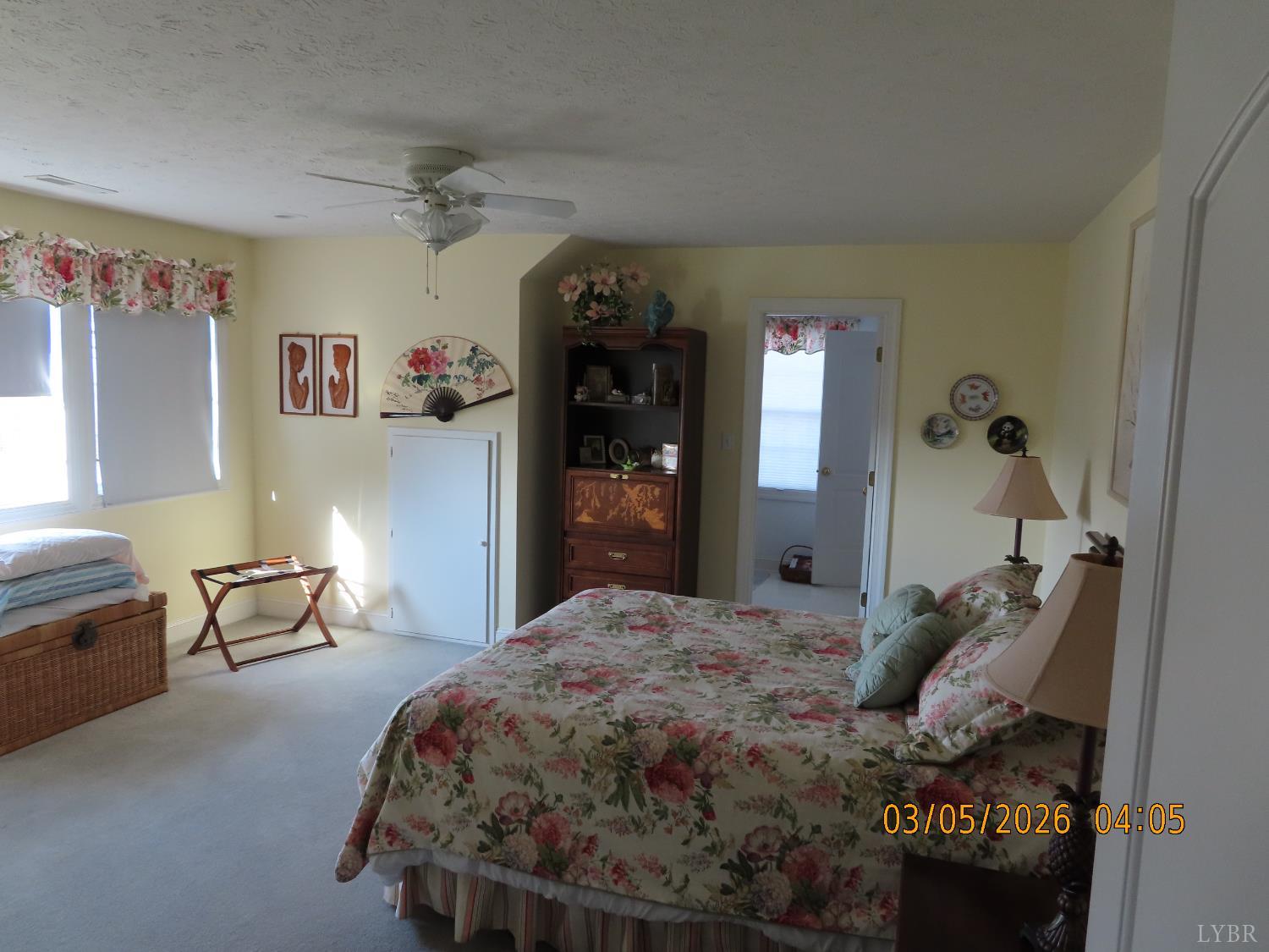 6485 Falling Creek Road Bedford, VA 24523 - Photo 20 of 50 a bedroom with a large bed and a chandelier