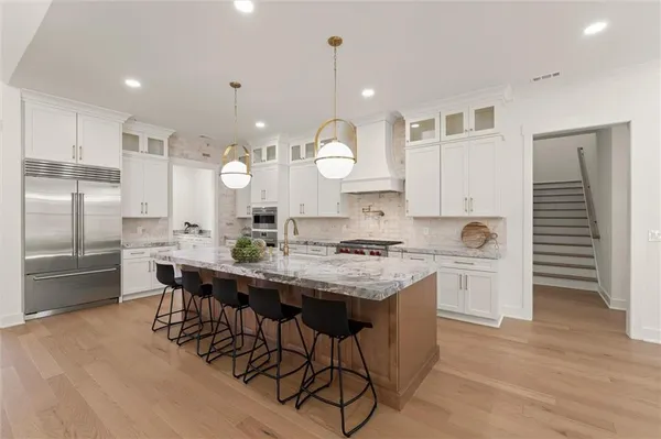 a kitchen with a dining table chairs and view of living room