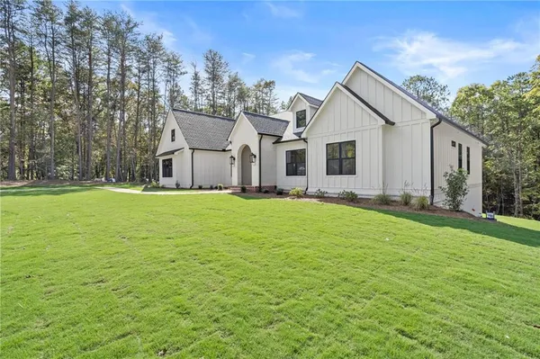 an aerial view of a house with garden space and outdoor seating