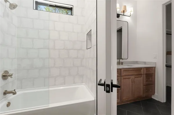 a bathroom with a double vanity sink toilet and shower