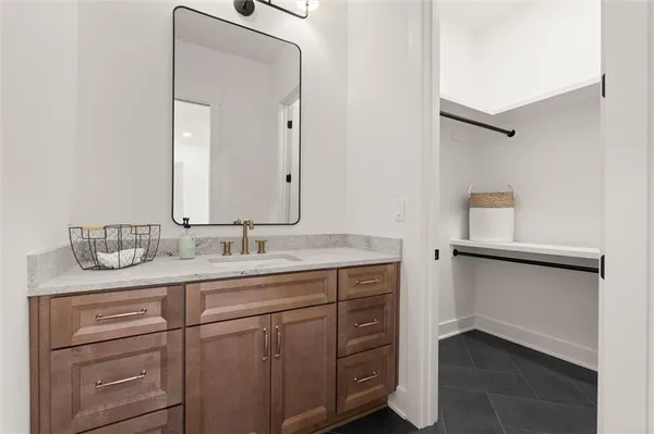an empty room with wooden floor chandelier fan and windows