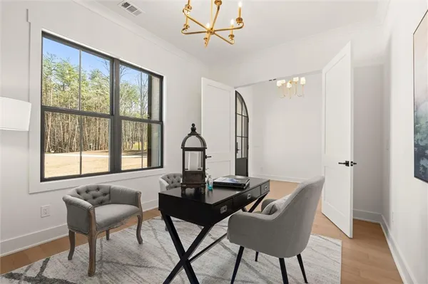 a living room with furniture a fireplace and a chandelier