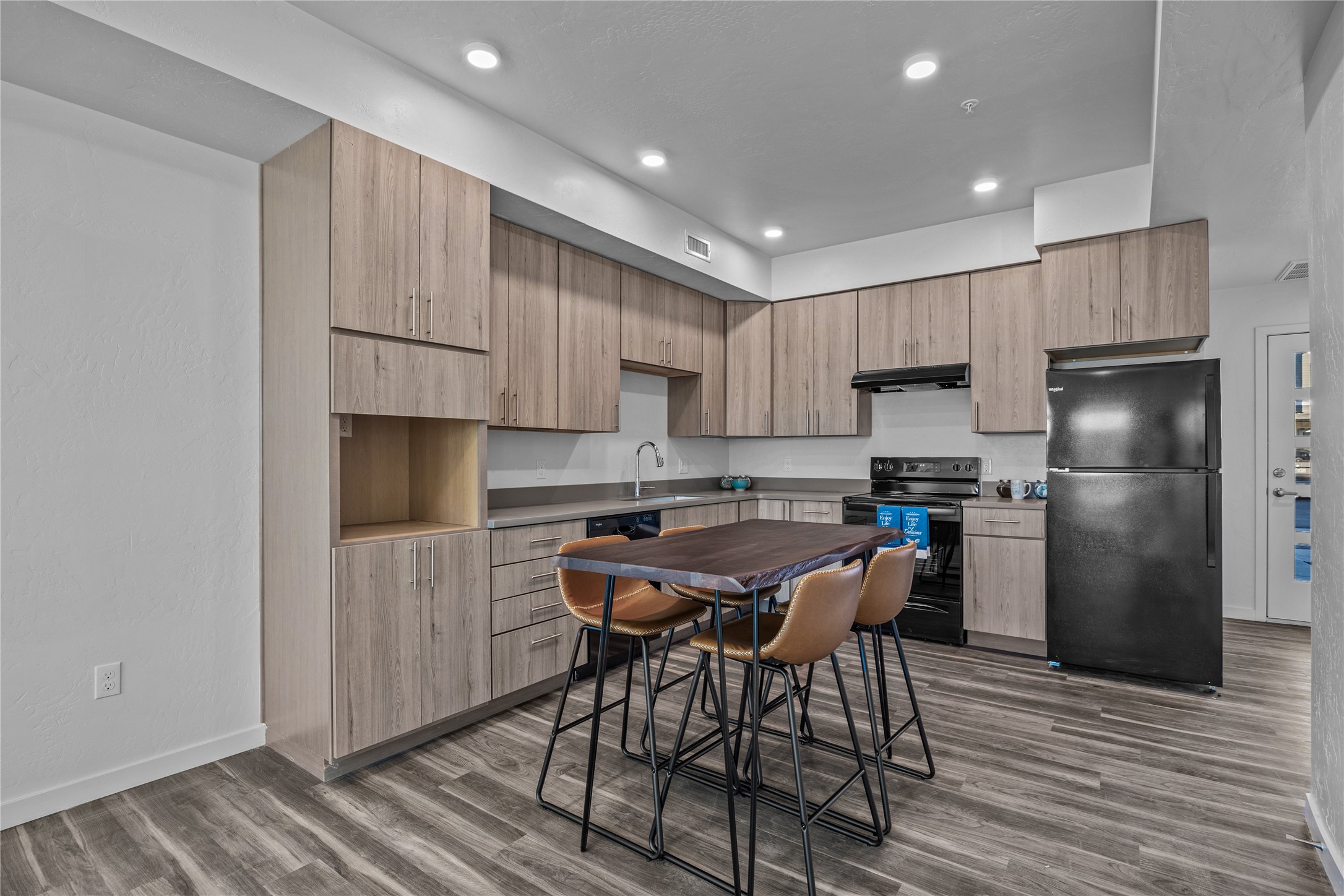 702 Makenzie River Road Fruita, CO 81521 - Photo 4 of 7 a kitchen with stainless steel appliances a refrigerator a stove a sink and white cabinets with wooden floor