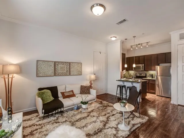 a living room with furniture and kitchen view