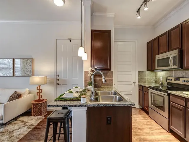 a kitchen with a sink stove and microwave