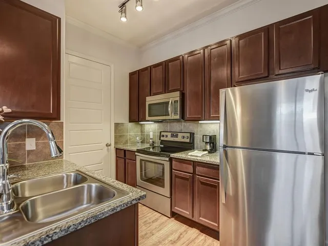 a kitchen with a refrigerator sink and microwave