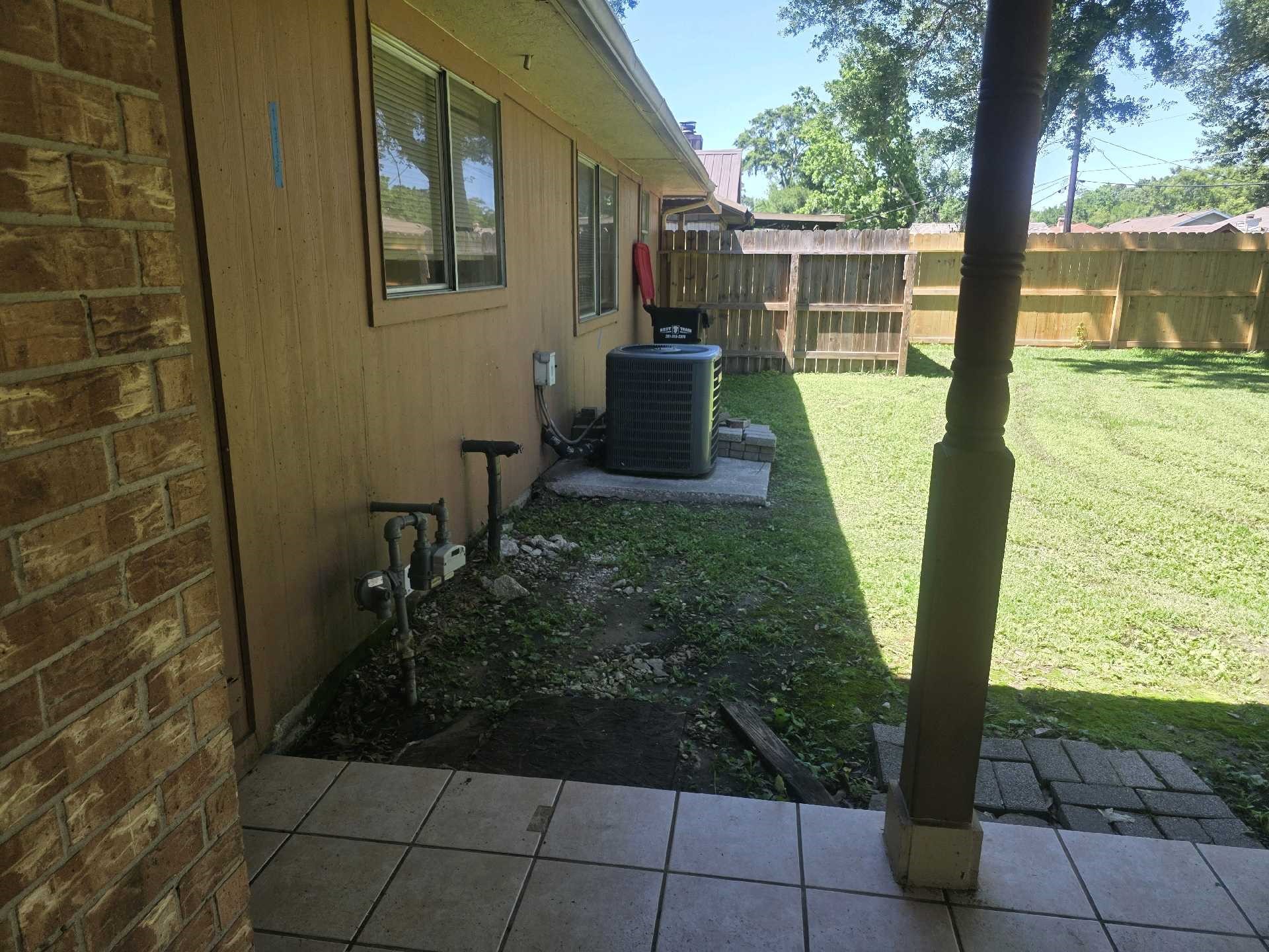 5006 Timber Ridge Street Baytown, TX 77521 - Photo 5 of 6 a view of a backyard with garden