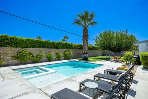 a view of a swimming pool and lounge chairs