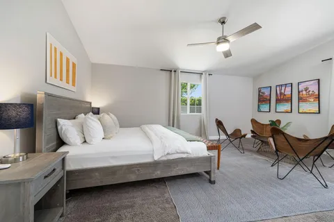 a bedroom with a bed and a table in it