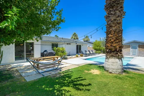 a house view with a sitting space and garden