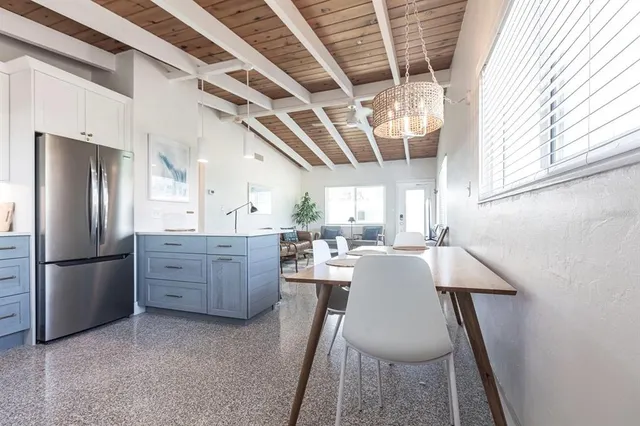 a kitchen with refrigerator and window