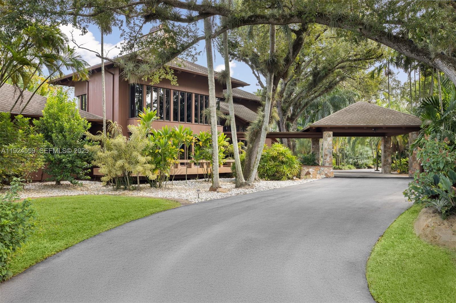 a view of a house with a yard and potted plants