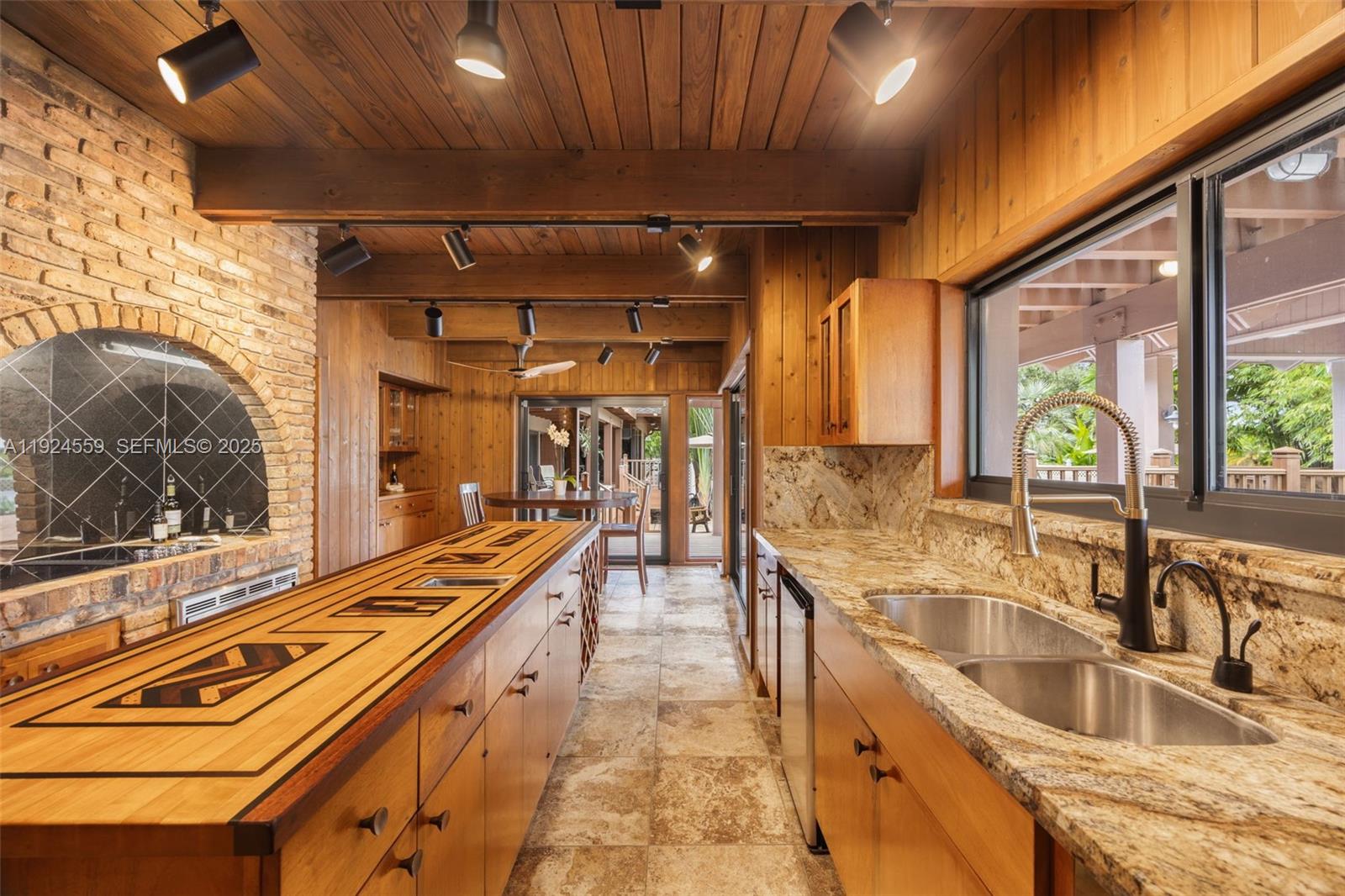 21675 Southwest 232nd Street Miami, FL 33170 - Photo 16 of 82 a kitchen with granite countertop a sink and a refrigerator