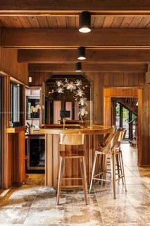 a spacious bedroom with a bed and glass window