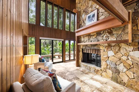 a bedroom with furniture and a large window