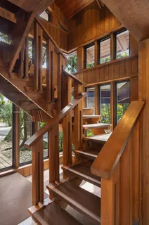 a bedroom with a bed and glass window