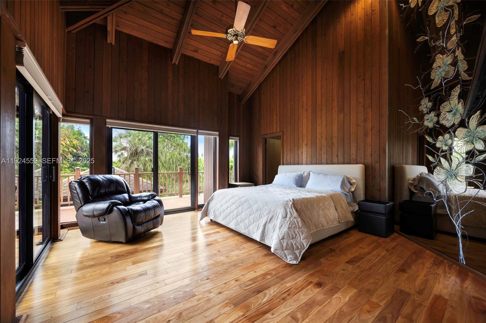 21675 Southwest 232nd Street Miami, FL 33170 - Photo 39 of 82 a spacious bedroom with a bed and glass window