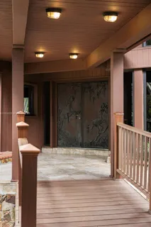 a view of a porch with furniture and floor to ceiling window