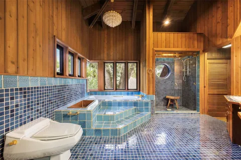 a view of swimming pool with a table and chairs under an umbrella
