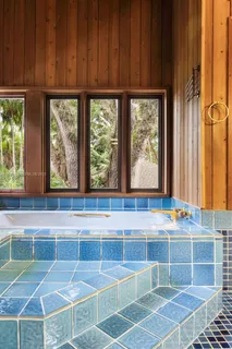 a view of a swimming pool with lawn chairs under an umbrella