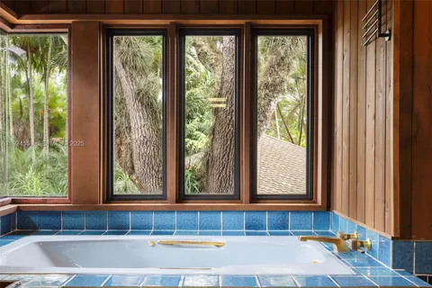 a view of a swimming pool with deck and furniture