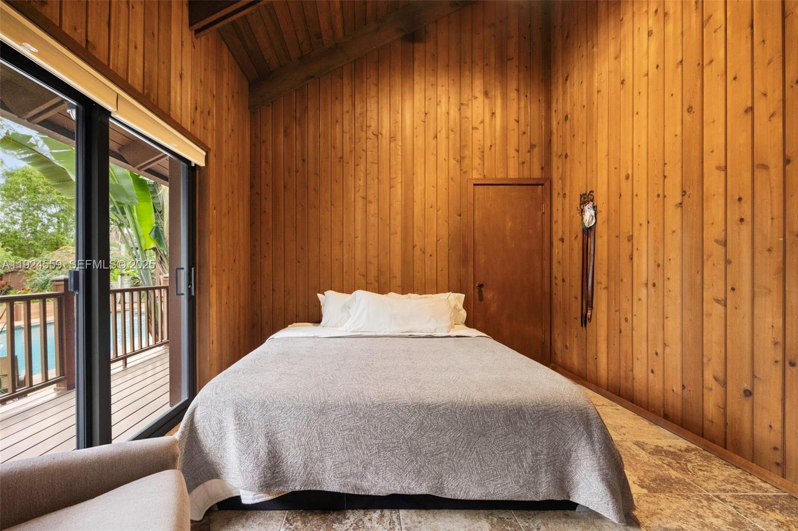 21675 Southwest 232nd Street Miami, FL 33170 - Photo 50 of 82 a bedroom with a bed and glass window