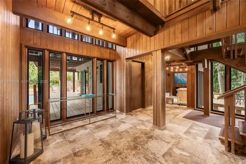 a living room with furniture and a floor to ceiling window