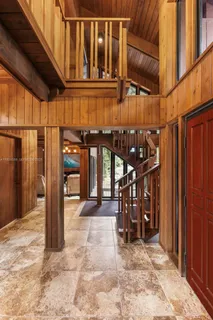 a kitchen with granite countertop a sink and a refrigerator