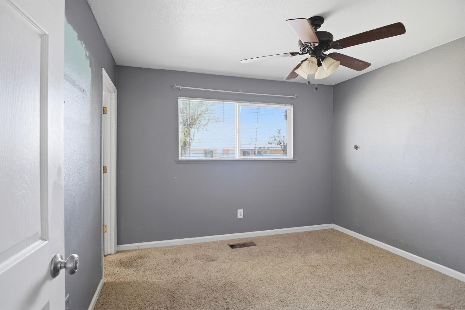1409 Stonum Road Modesto, CA 95351 - Photo 17 of 40 a view of room with window and ceiling fan