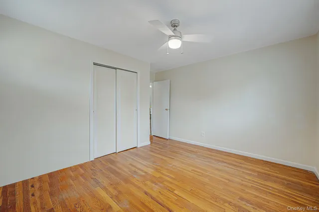 a view of a room with wooden floor and cabinet