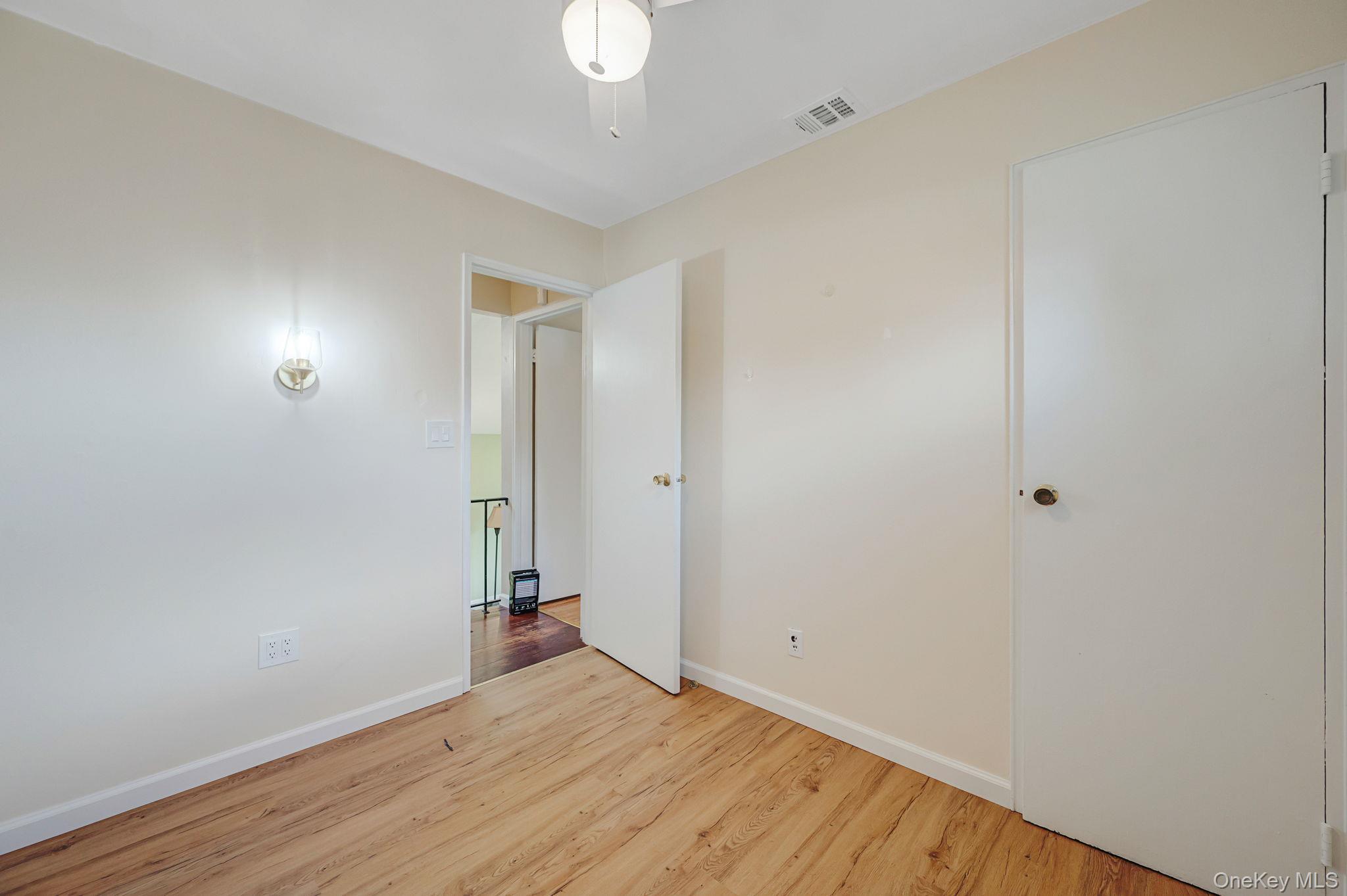 10 Laurie Road Brentwood, NY 11717 - Photo 16 of 29 Empty room featuring wood finished floors and baseboards