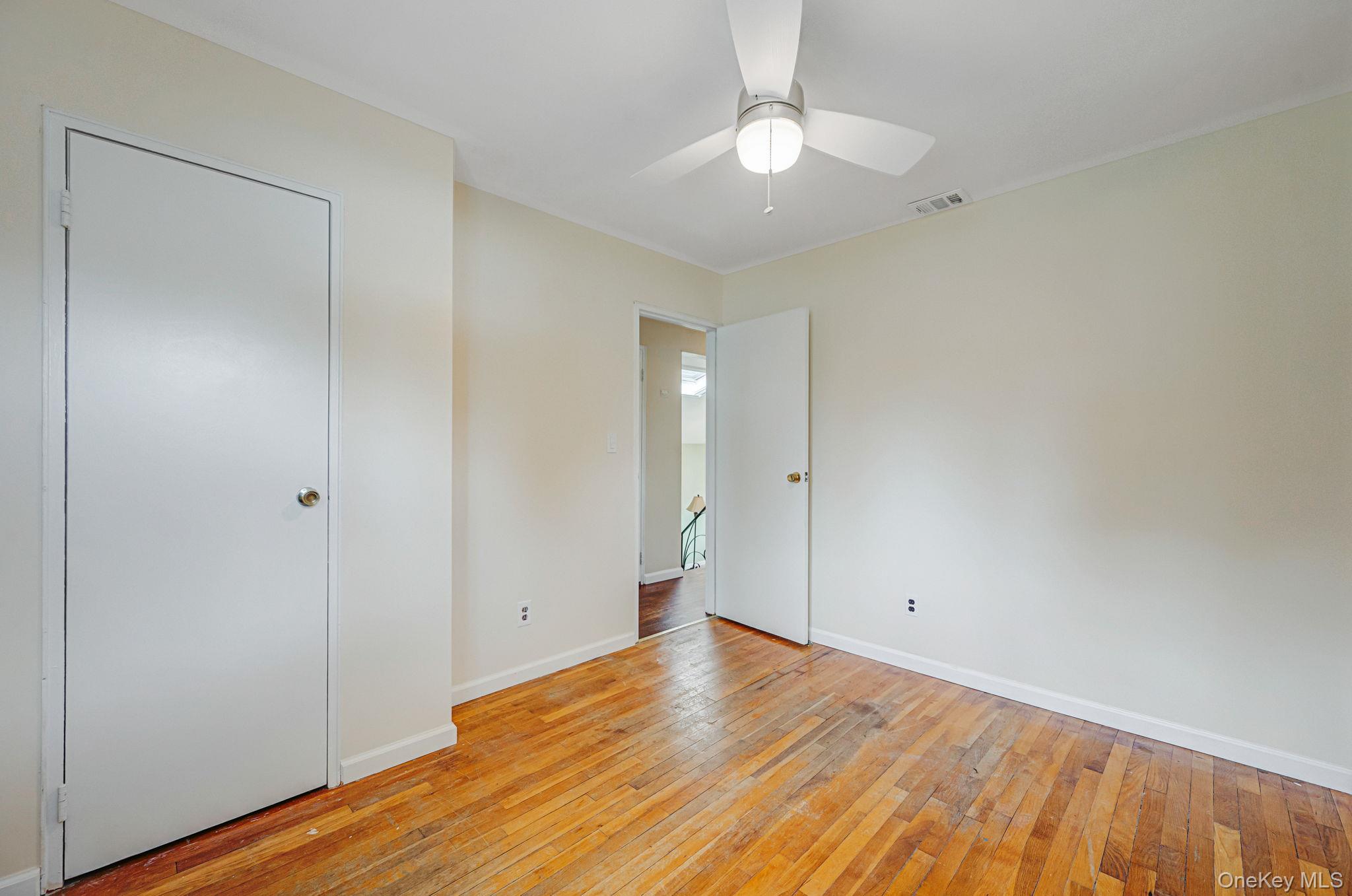10 Laurie Road Brentwood, NY 11717 - Photo 18 of 29 Unfurnished bedroom with light wood finished floors and ceiling fan