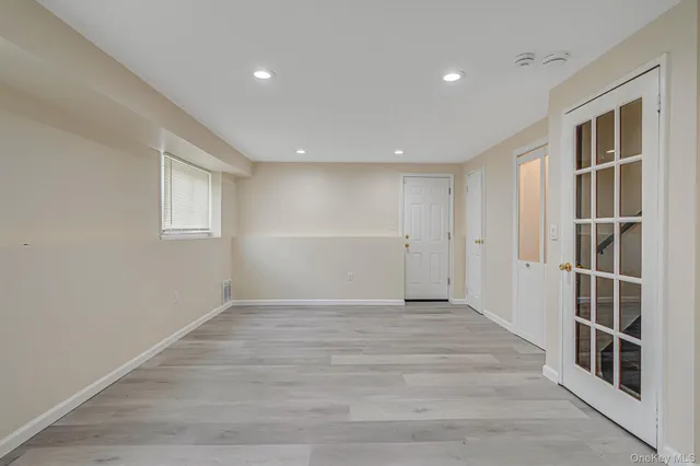 a view of an empty room with closet and window