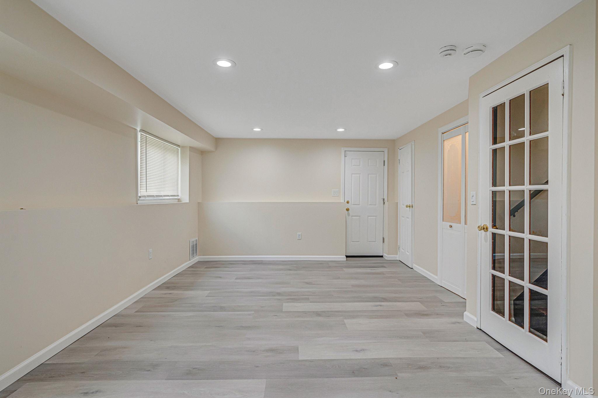 10 Laurie Road Brentwood, NY 11717 - Photo 19 of 29 Unfurnished room featuring recessed lighting and light wood-style flooring