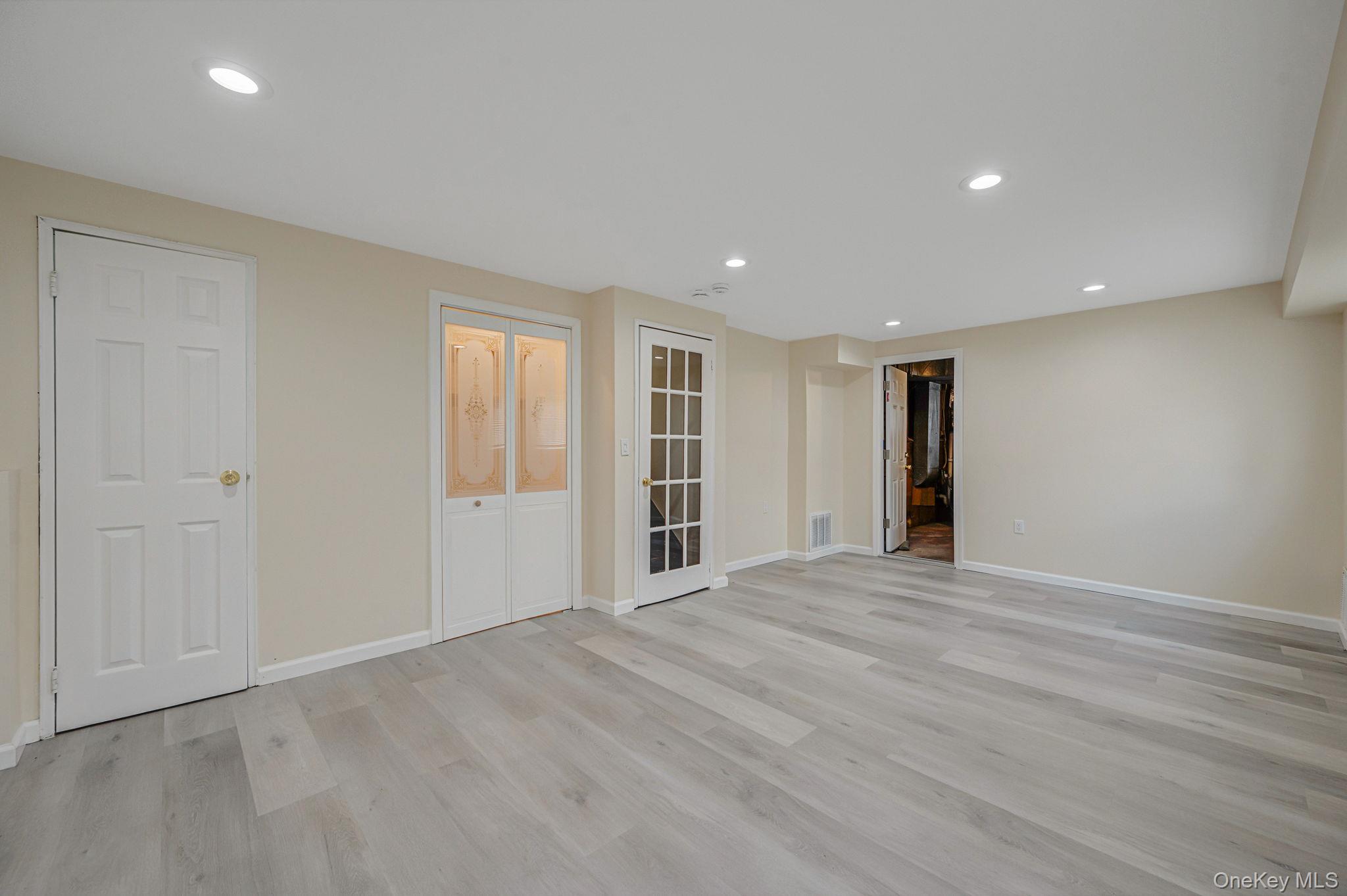 10 Laurie Road Brentwood, NY 11717 - Photo 20 of 29 Spare room with light wood-style flooring and recessed lighting