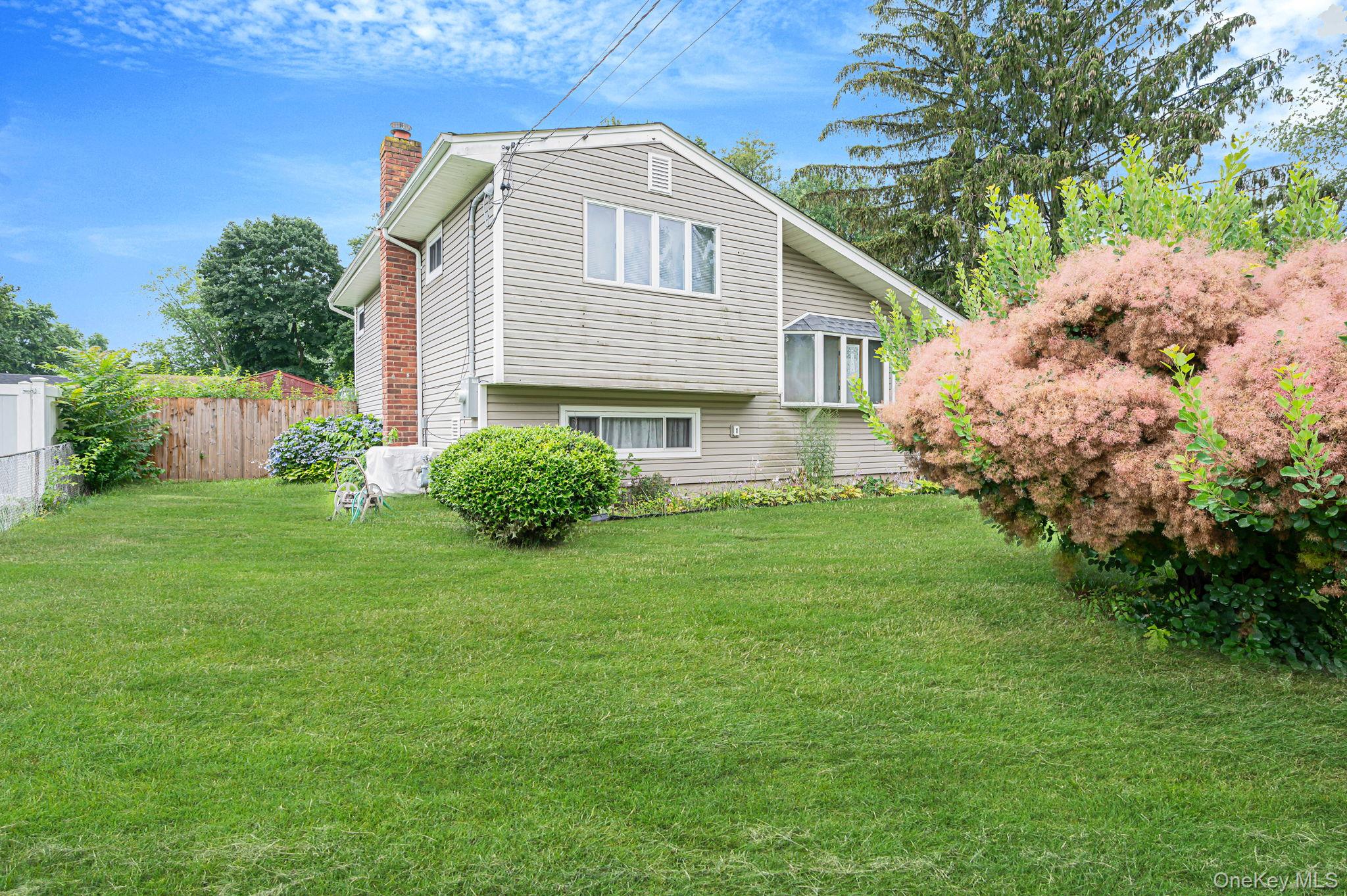 10 Laurie Road Brentwood, NY 11717 - Photo 2 of 29 View of property exterior with a chimney