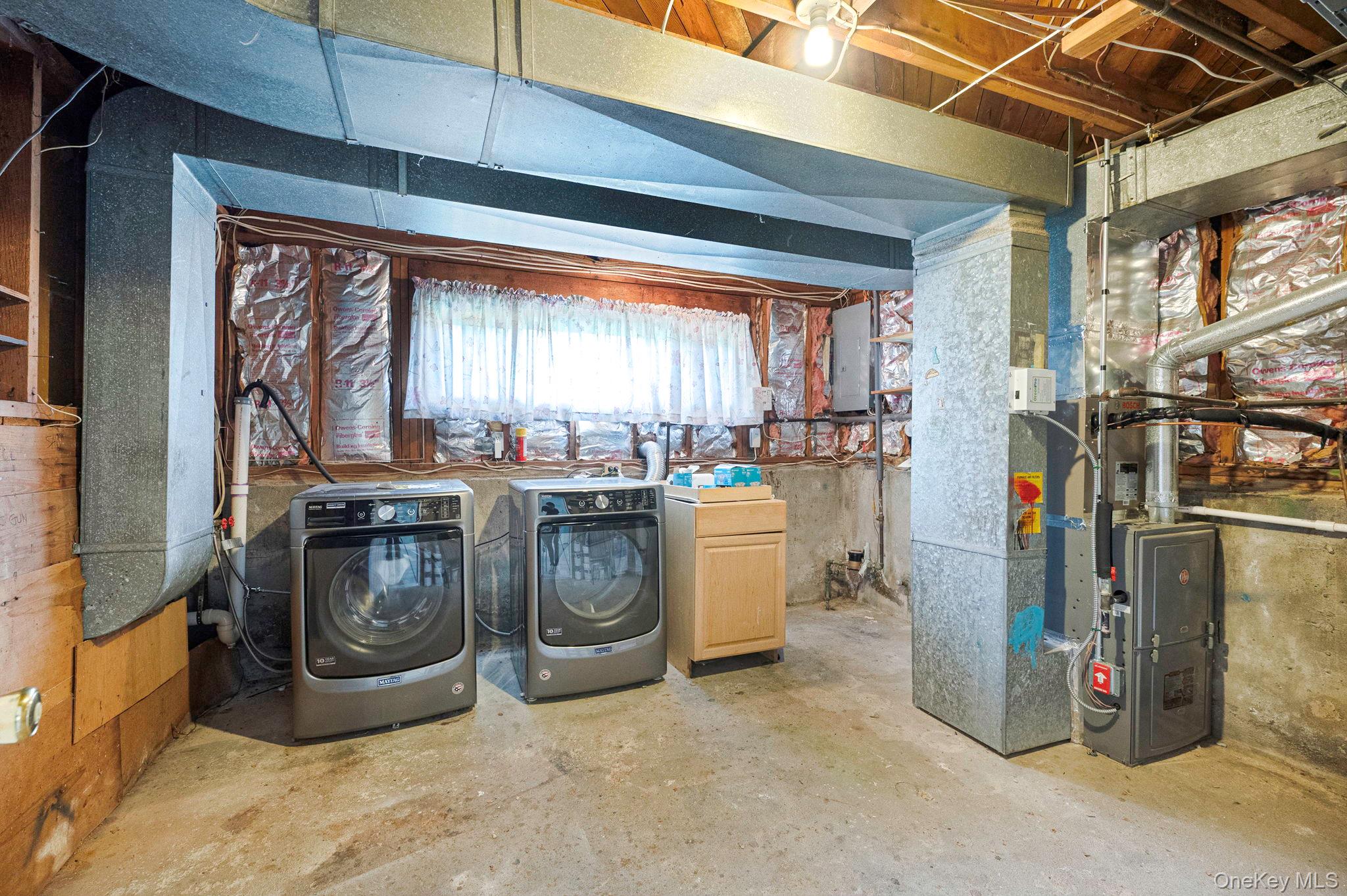 10 Laurie Road Brentwood, NY 11717 - Photo 23 of 29 Basement with independent washer and dryer, heating unit, and electric panel