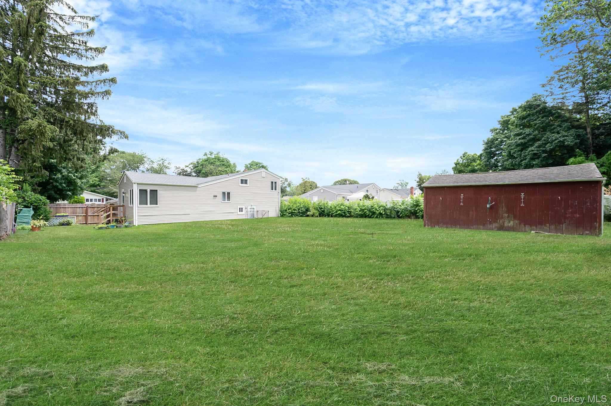 10 Laurie Road Brentwood, NY 11717 - Photo 26 of 29 View of green lawn with an outbuilding