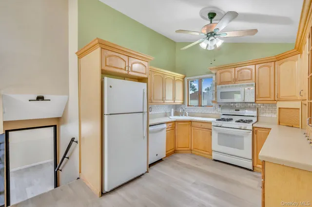 a view of a refrigerator in kitchen and wooden floor