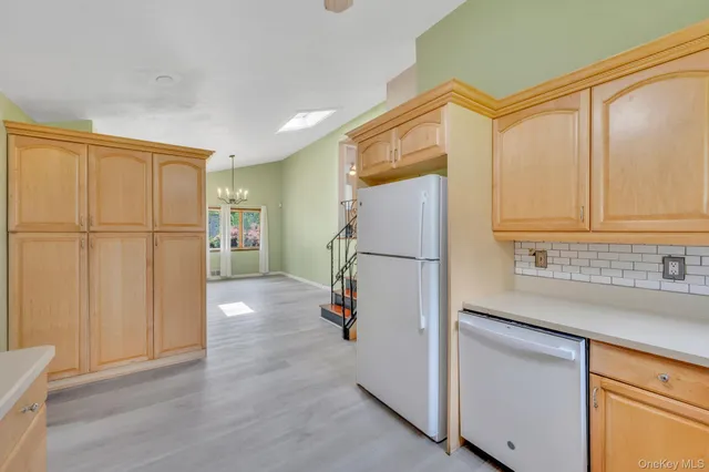 a kitchen with granite countertop cabinets and wooden floor