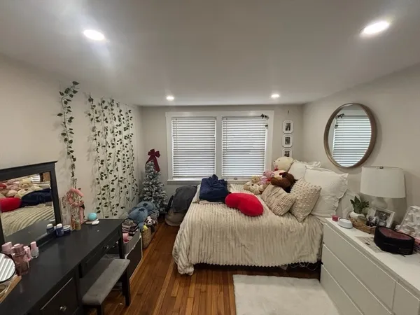 a bed room with a bed window and a flat screen tv