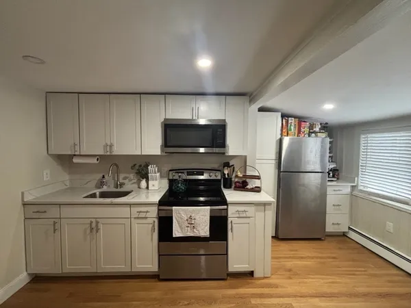 a kitchen with a sink a stove and refrigerator