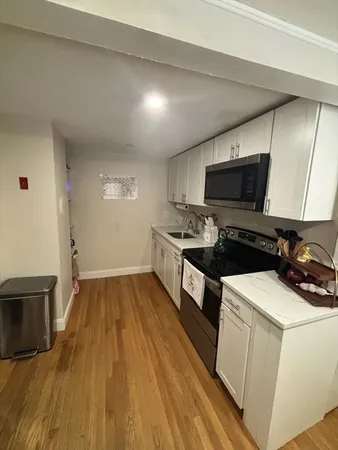 a kitchen that has a sink and a stove top oven