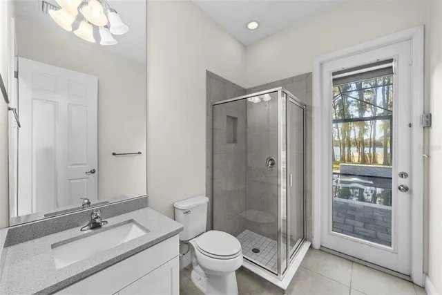 a spacious bathroom with a granite countertop sink mirror and shower